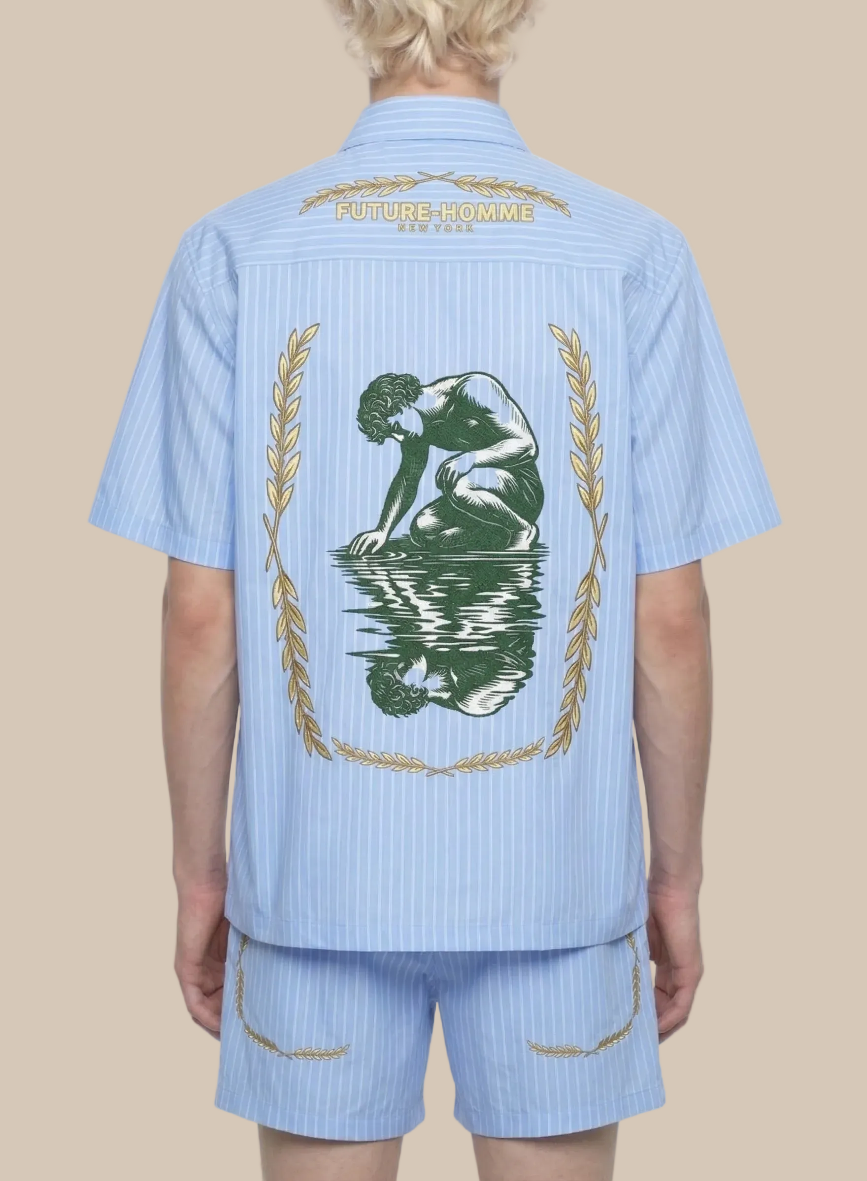 Light blue shirt with a design on the back worn by a person, on a white background