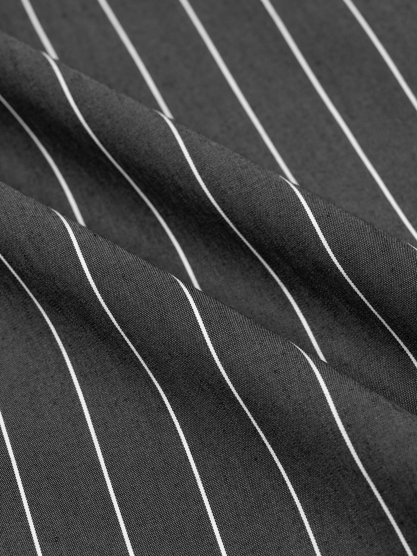 Close-up of black fabric with white pinstripes