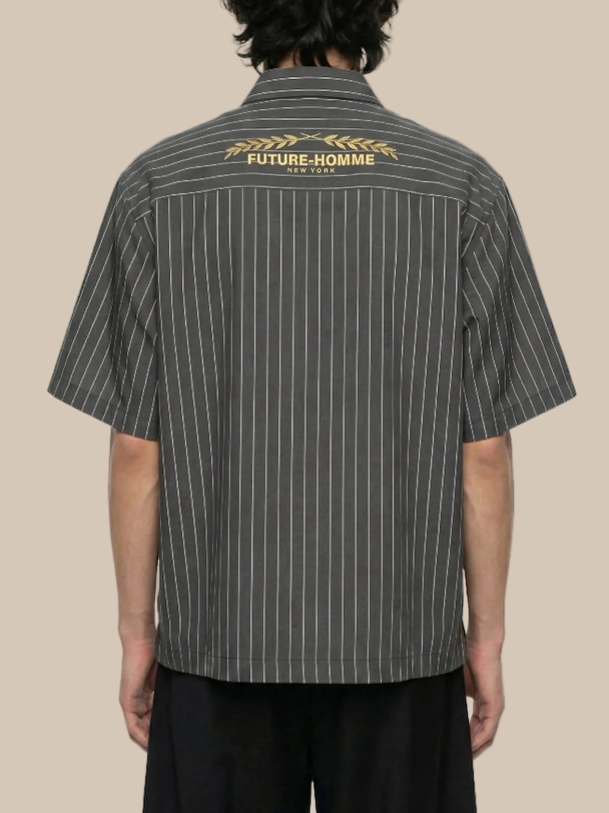 Person wearing a black pinstripe shirt with 'FUTURE-HOMME' branding on the back.
