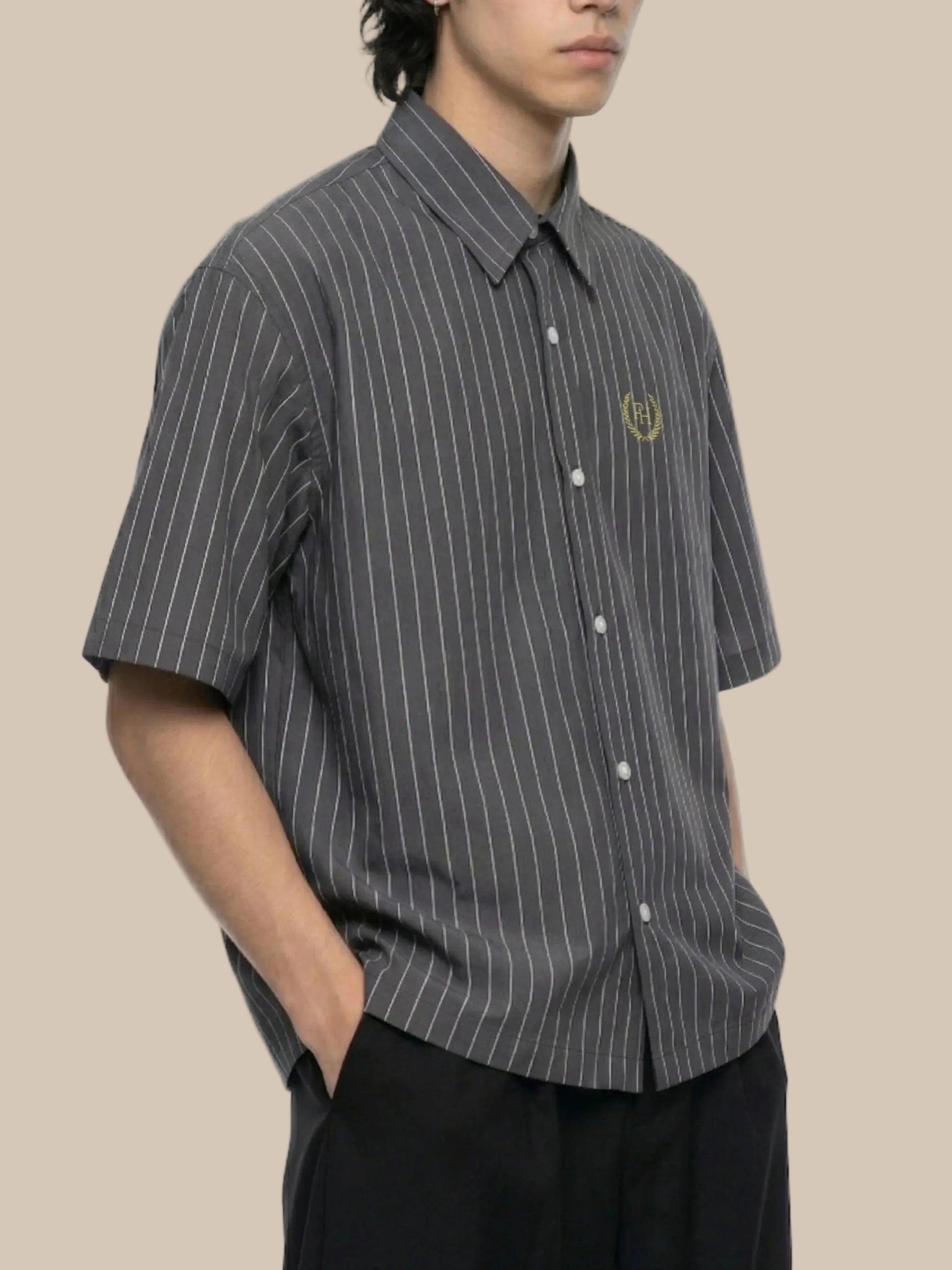 A person wearing a gray Future-Homme pinstripe short sleeve shirt with logo on a white background.