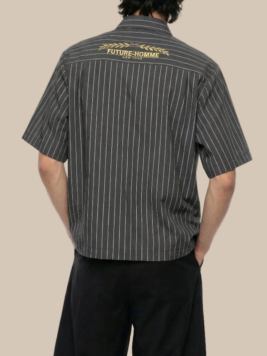Person wearing a black pinstripe shirt with 'Future Homme' branding on the back.