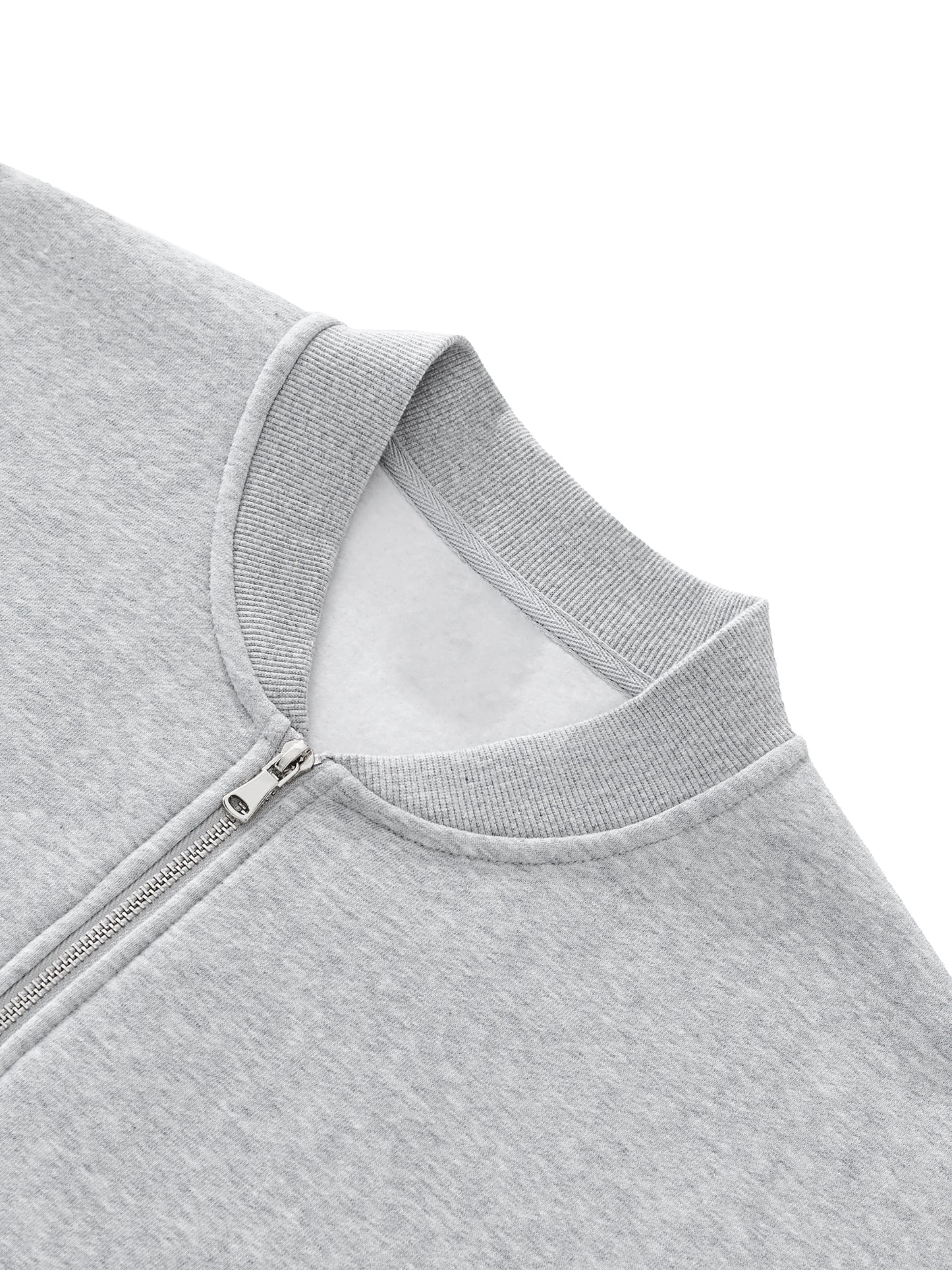 Future-Homme Fleece Please up-close of Varsity Jacket neckline and zipper on a white background. 