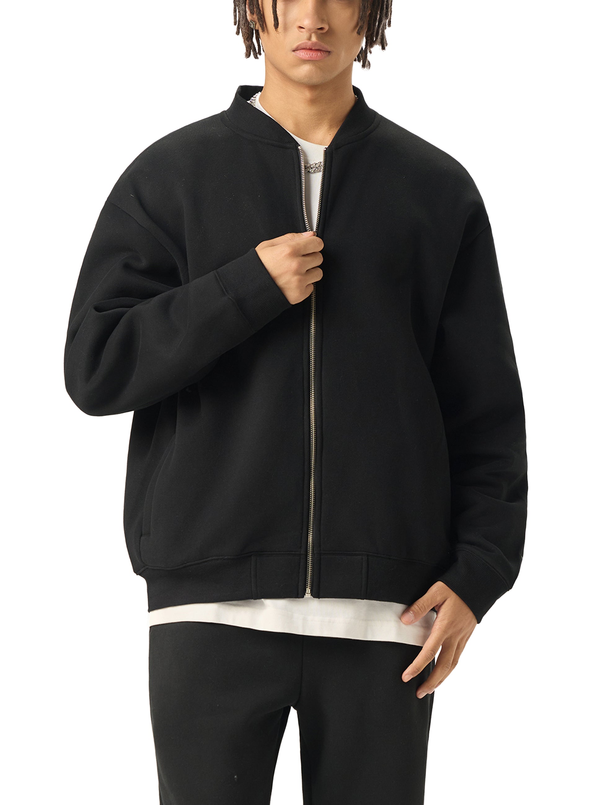 A Future-Homme model wearing the Fleece Please Varsity Jacket front side in black on a white background. 