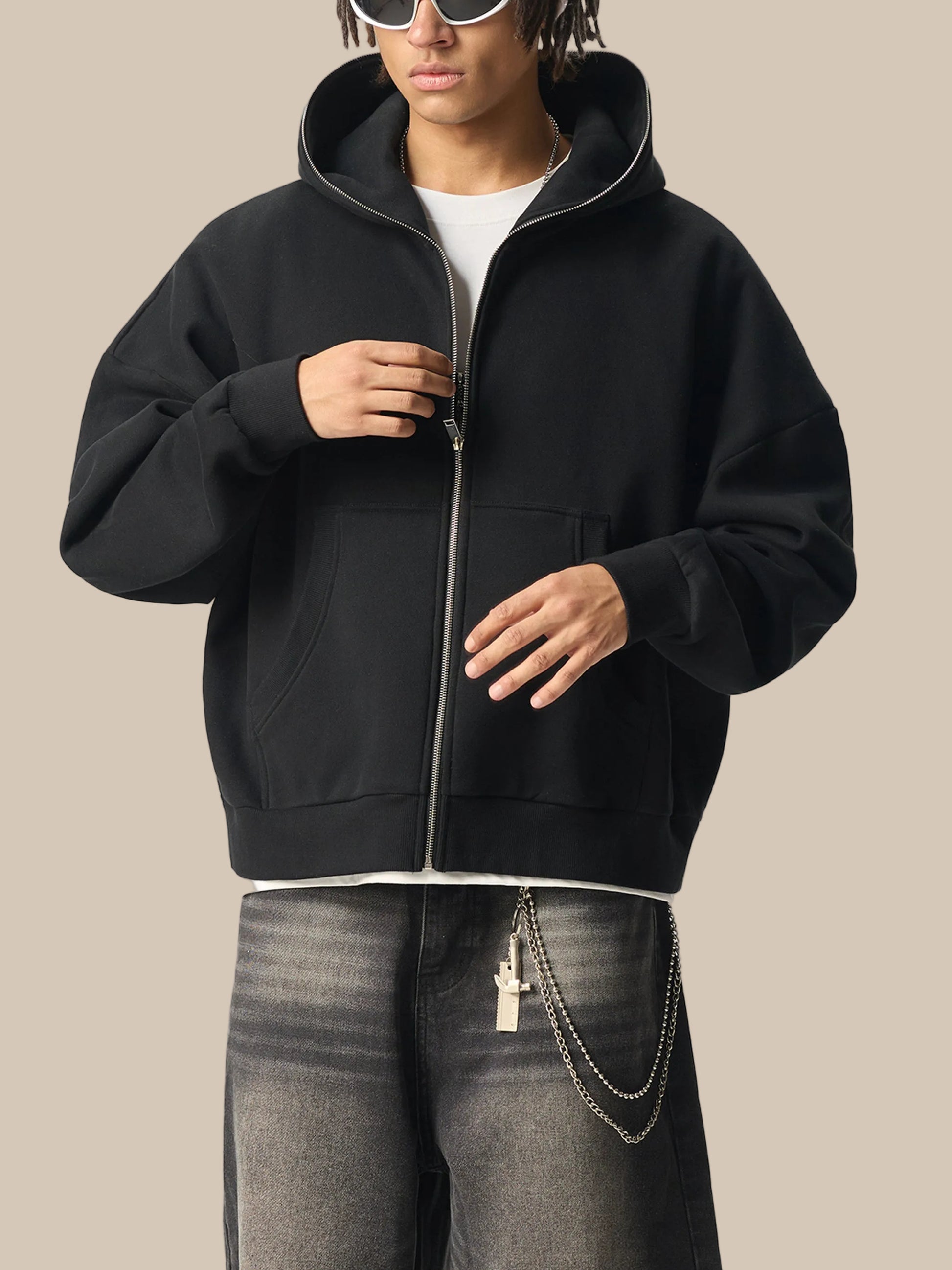Person wearing a black future-homme zip-up hoodie with a white shirt underneath on a white background