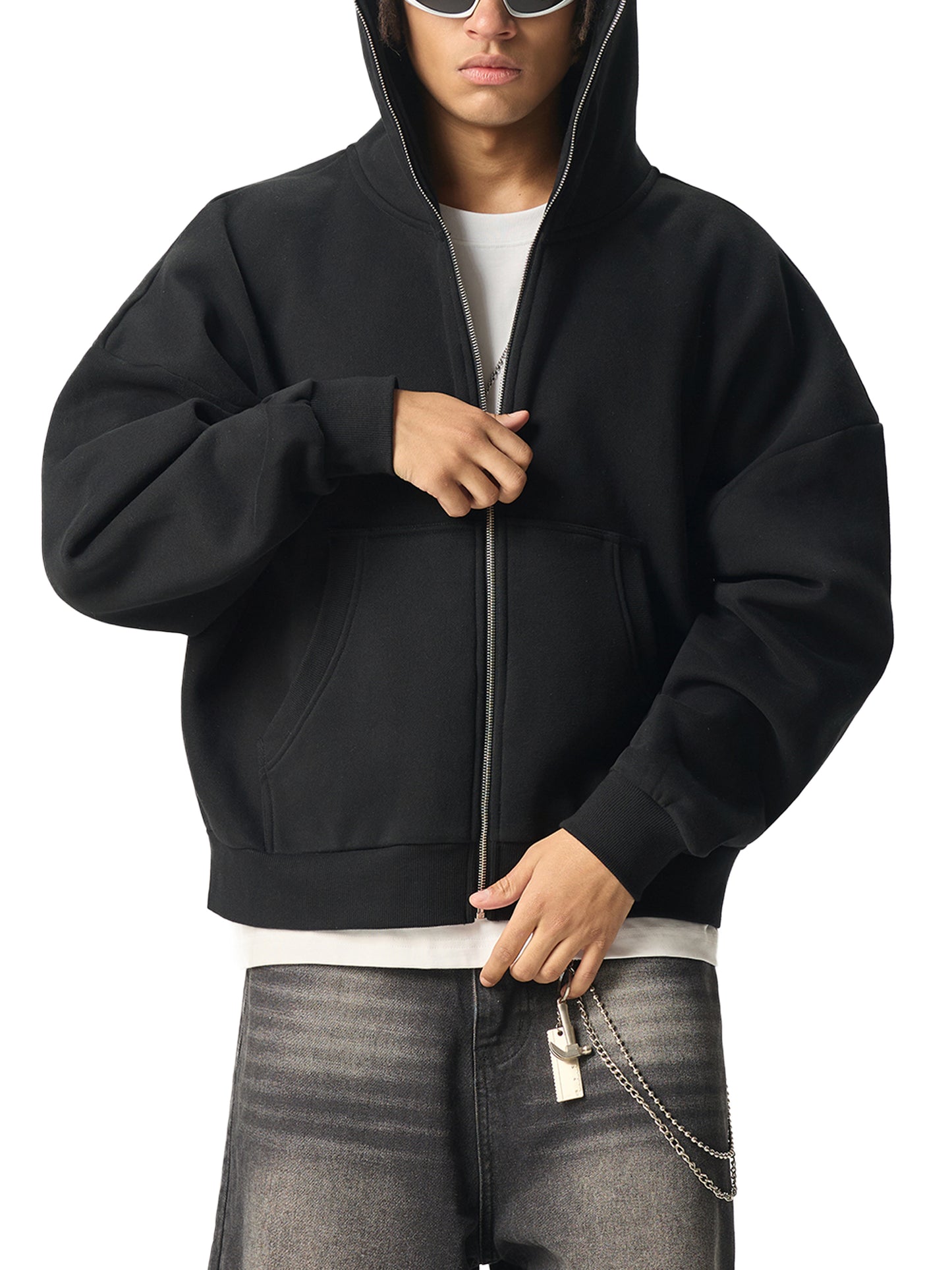 A Future-Homme male model wearing the Fleece Please full zip hoodie with gray jeans on a white background. 