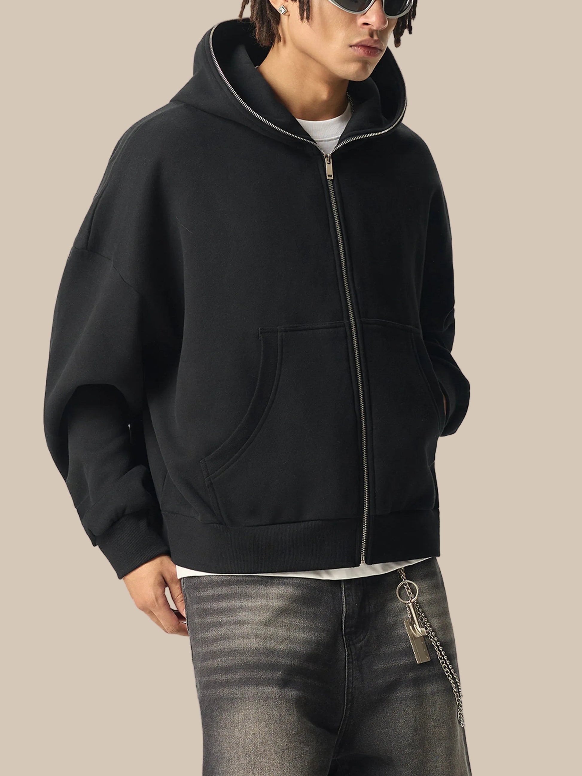 Person wearing a black future-homme hoodie with a white background
