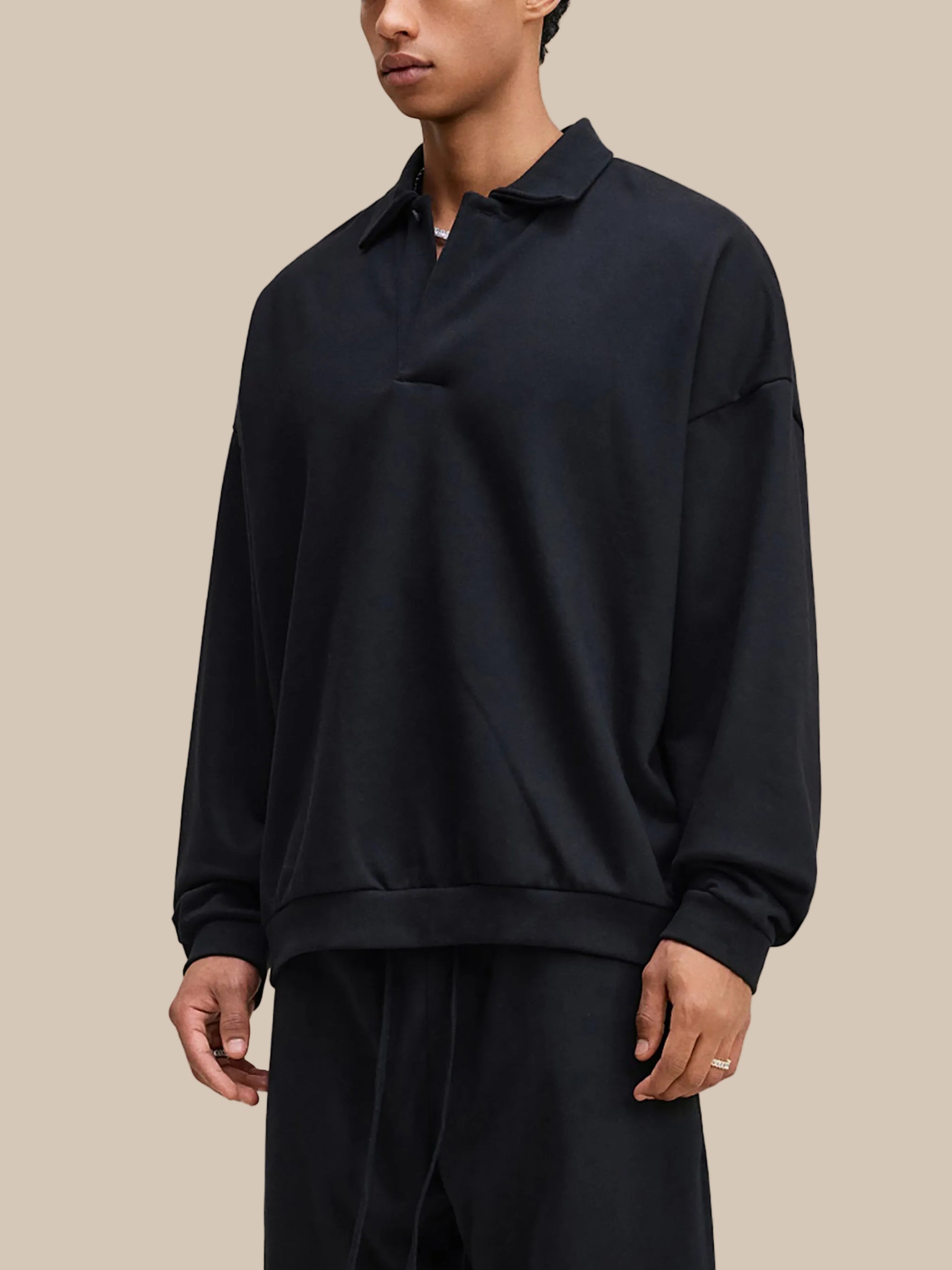 Person wearing a black long-sleeve shirt on a white background