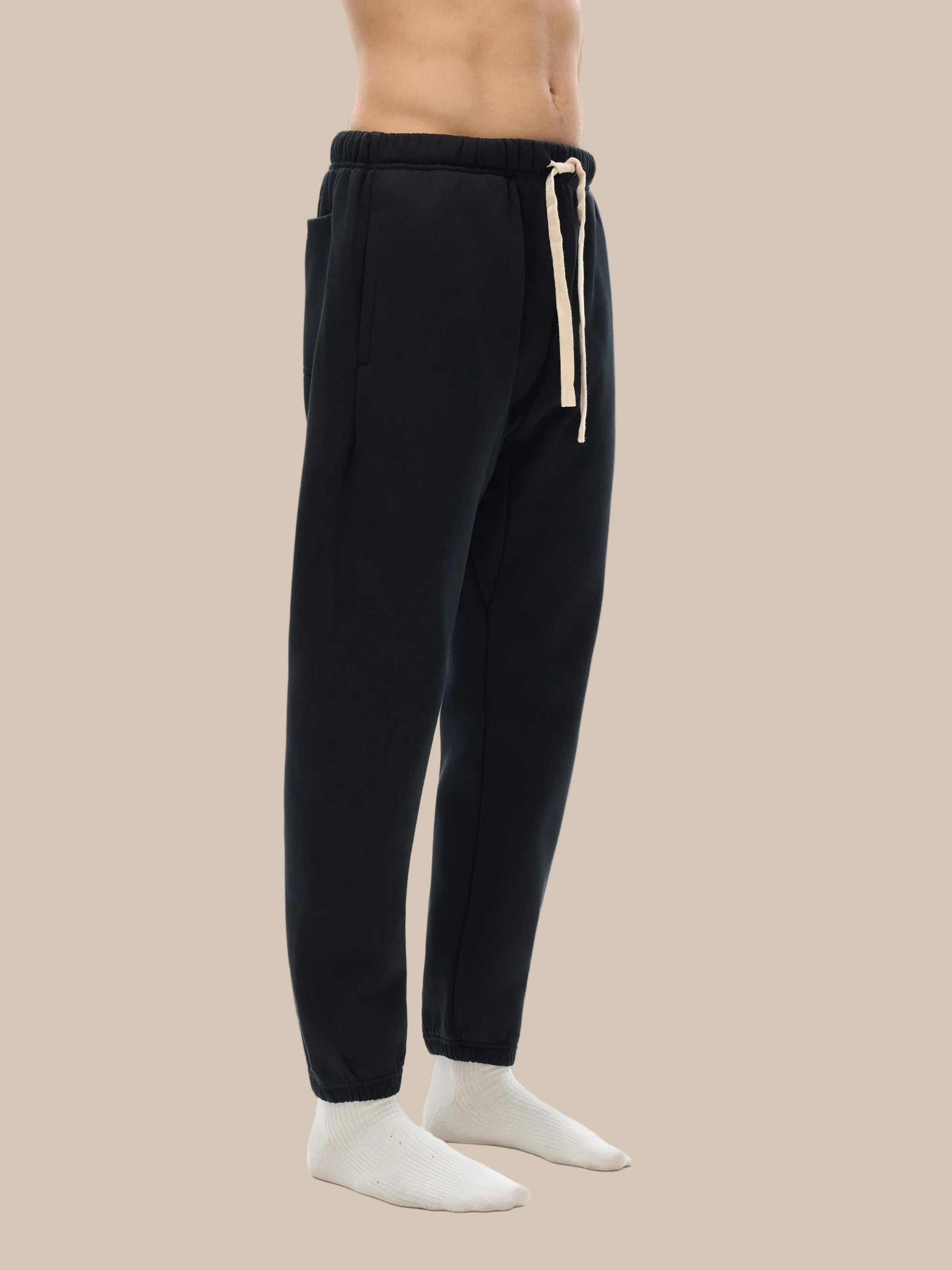 Black jogger pants with a drawstring on a white background