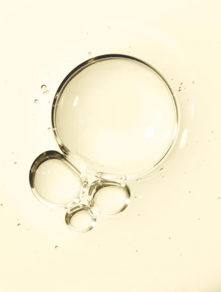 Close-up of bubbles in a liquid on a beige background