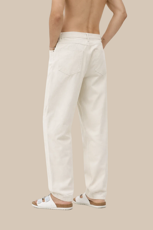 Person wearing white pants on a white background