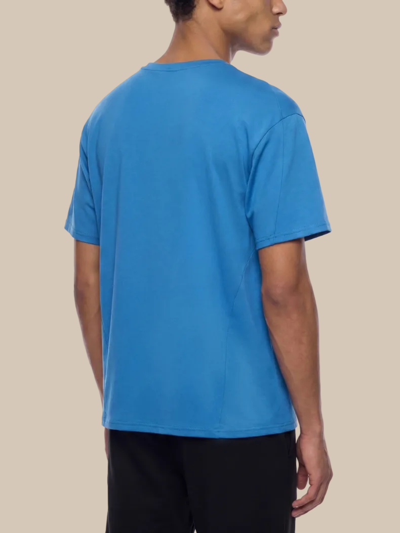 Person wearing a blue t-shirt on a white background