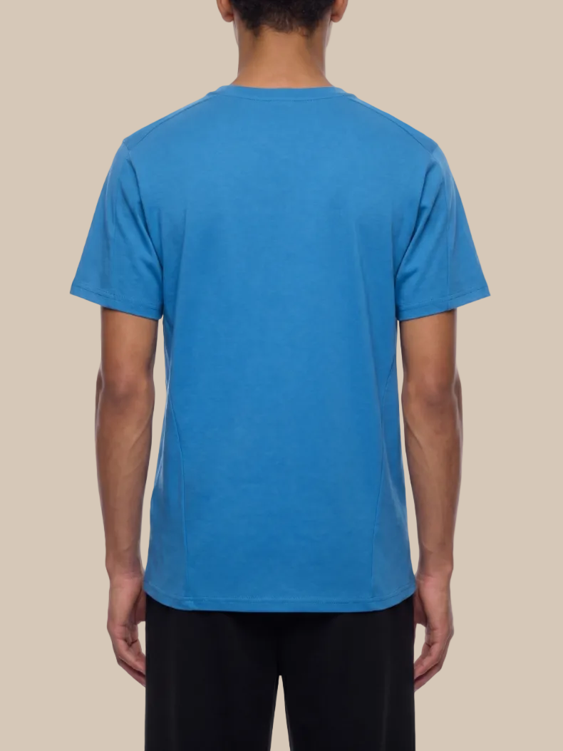 Person wearing a blue t-shirt on a white background