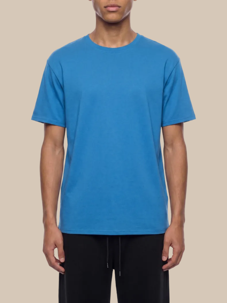 Person wearing a blue t-shirt on a white background