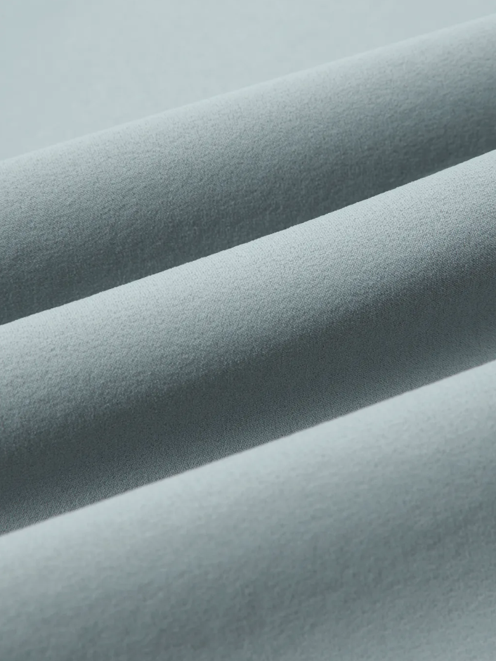 Close-up of textured light gray fabric with a soft sheen