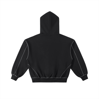Flat lay of the back of a black hoodie with white stitching on a white background