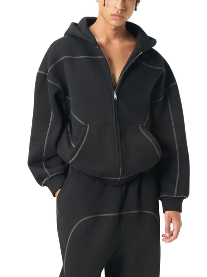 Male Model wearing a black hoodie with white stitching and a matching jogger on a white background