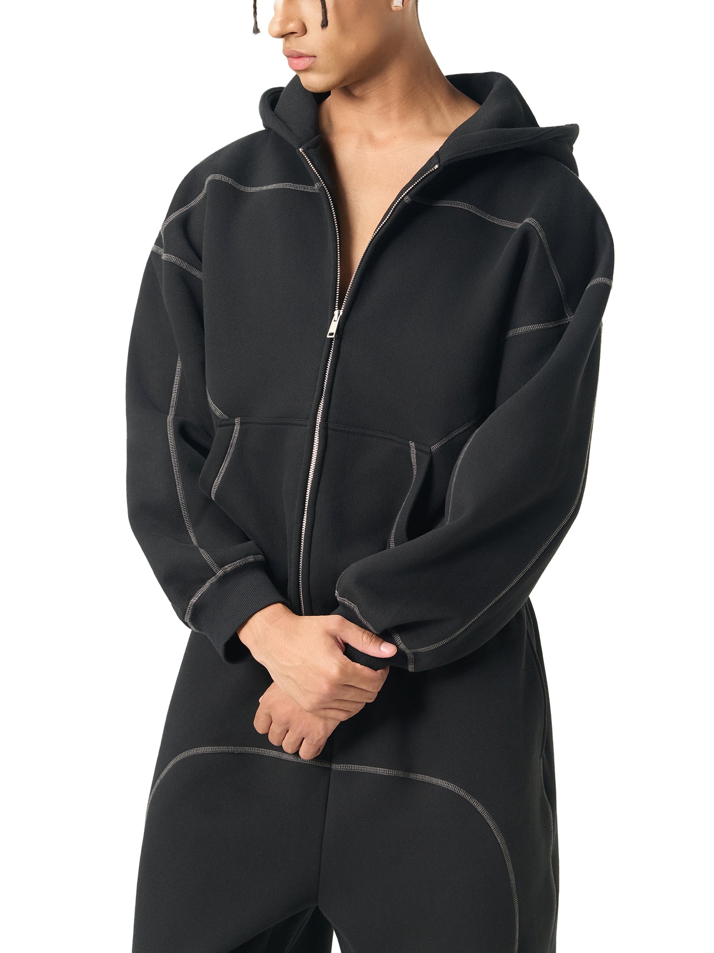 Person wearing a black fleece jacket on a white background
