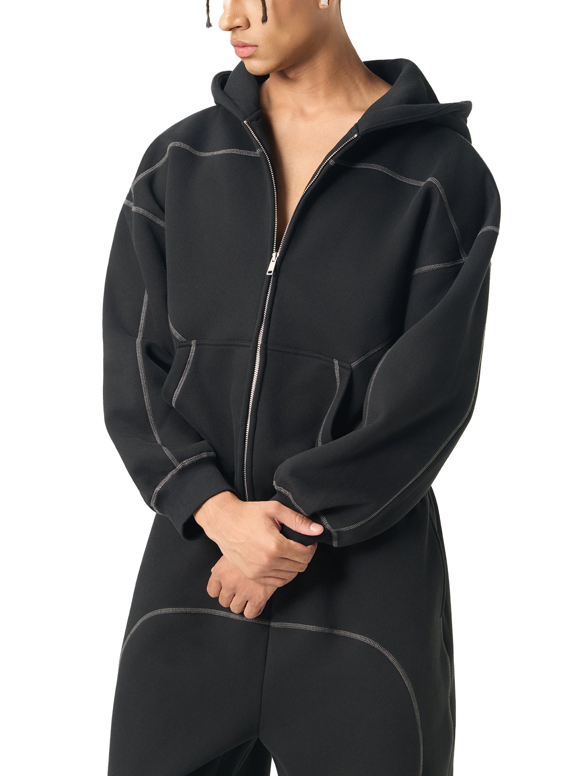 Person wearing a black fleece jacket on a white background