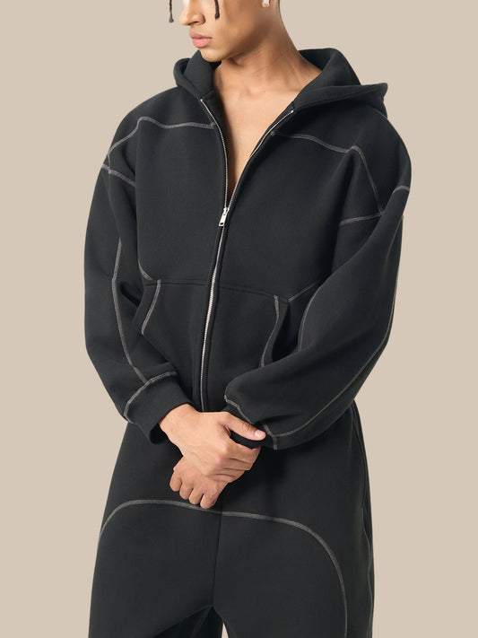 Person wearing a black fleece jacket on a white background