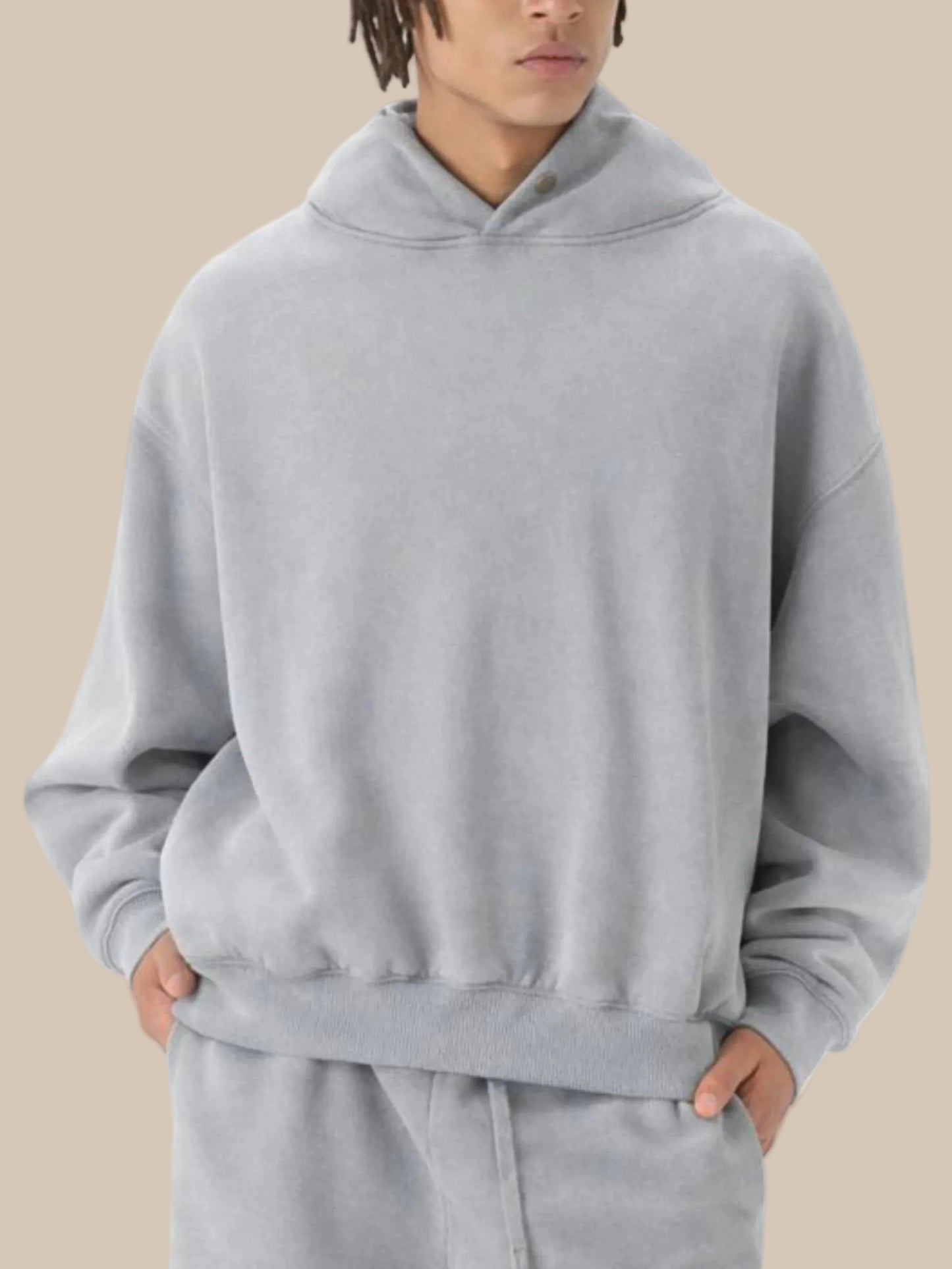 Person wearing a gray hoodie on a white background
