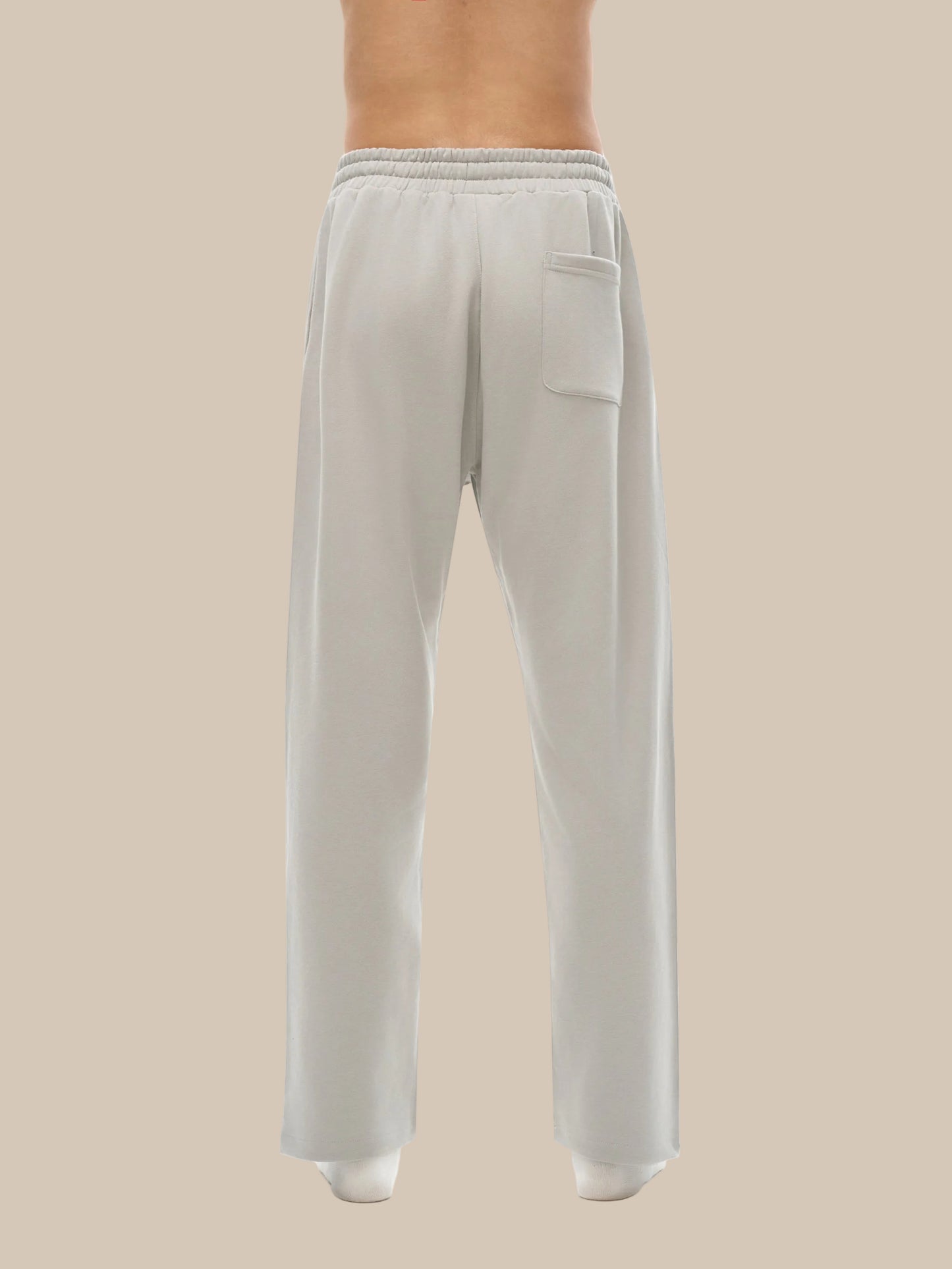 Light gray sweatpants worn by a person on a white background