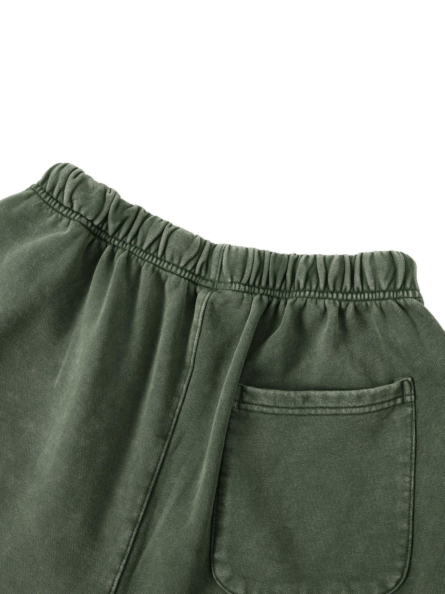 Close-up of green pants with an elastic waistband and pocket on a white background