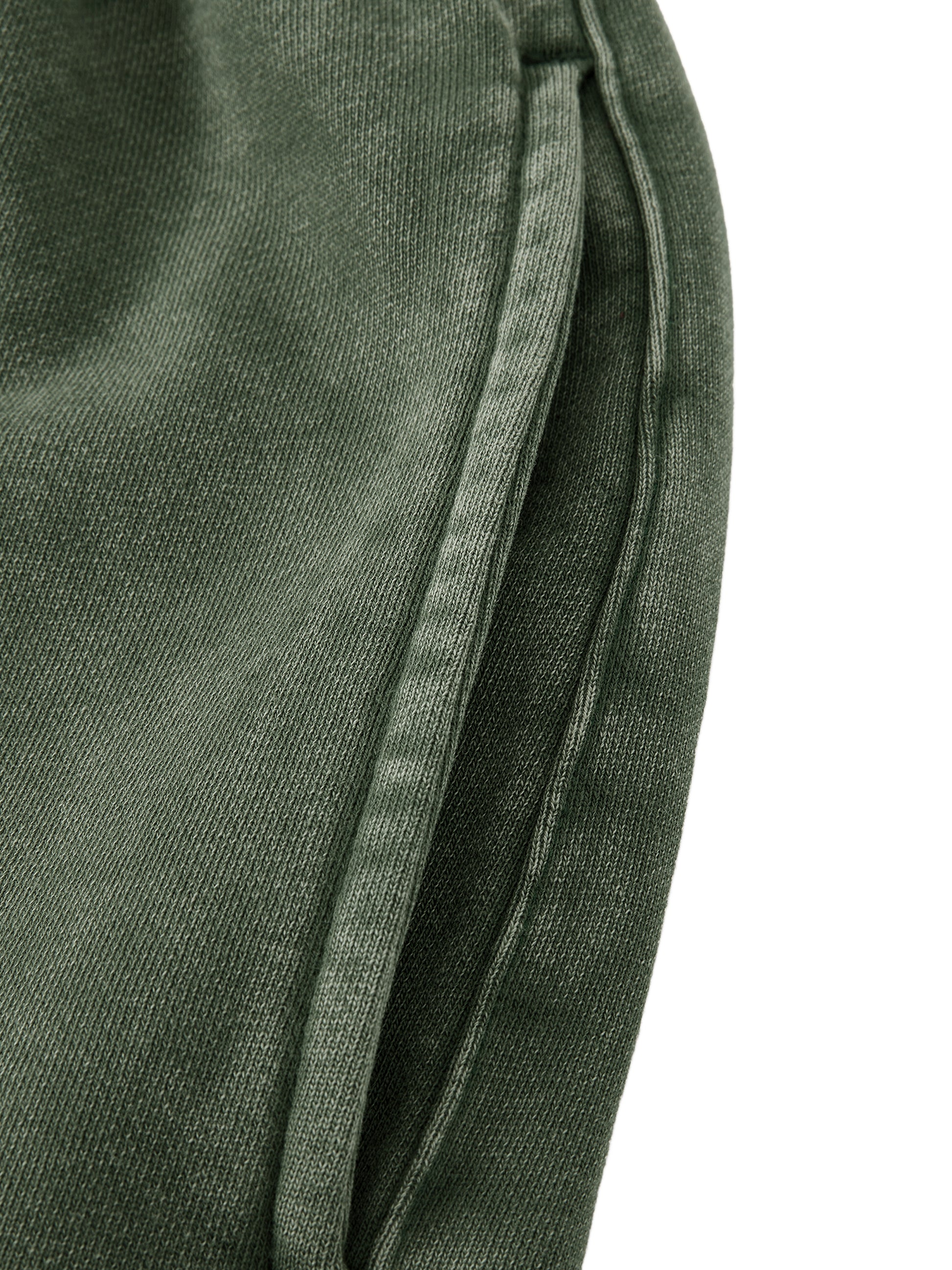 Close-up of green fabric with a white background