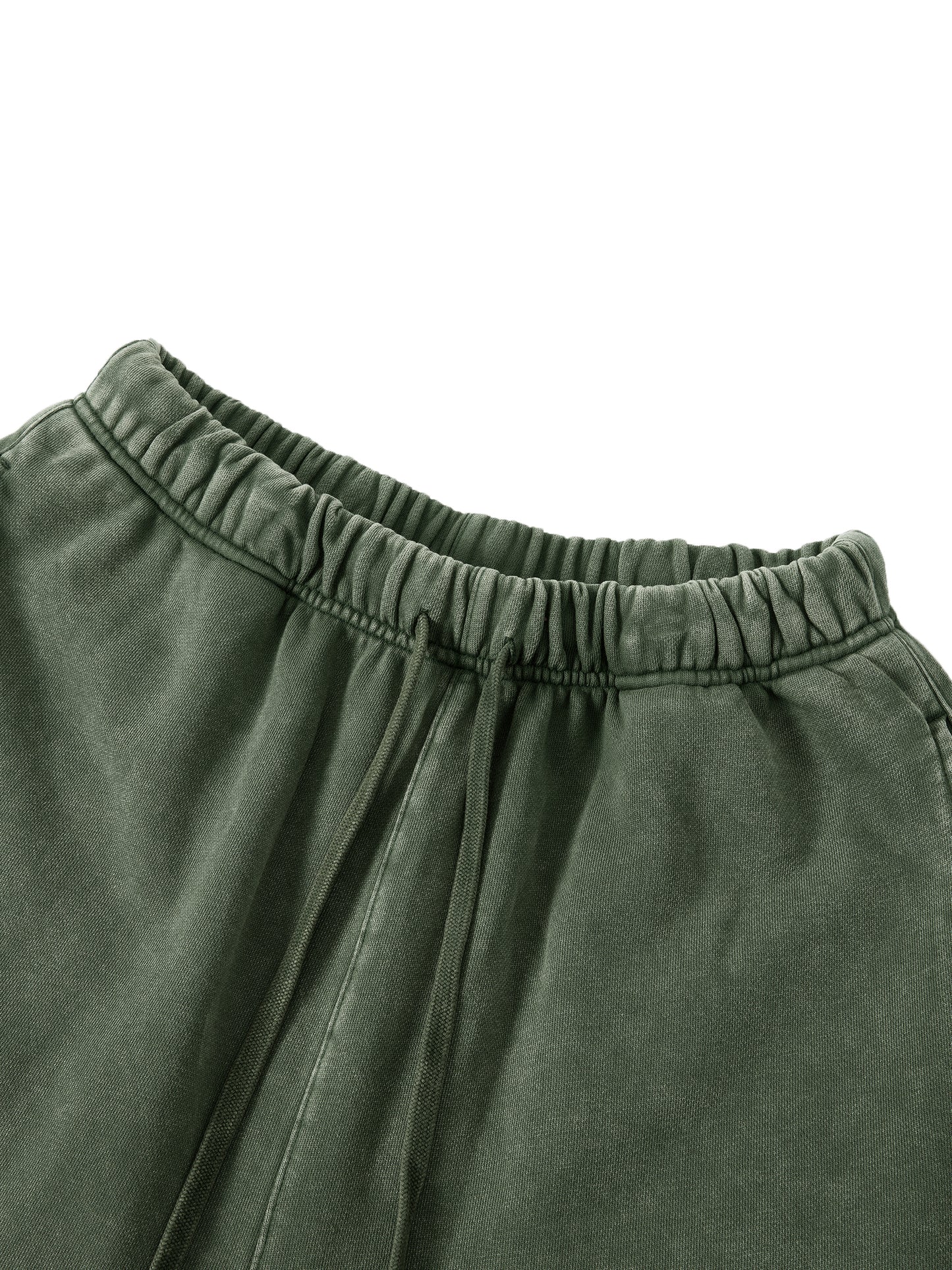 Close-up of green pants with an elastic waistband on a white background
