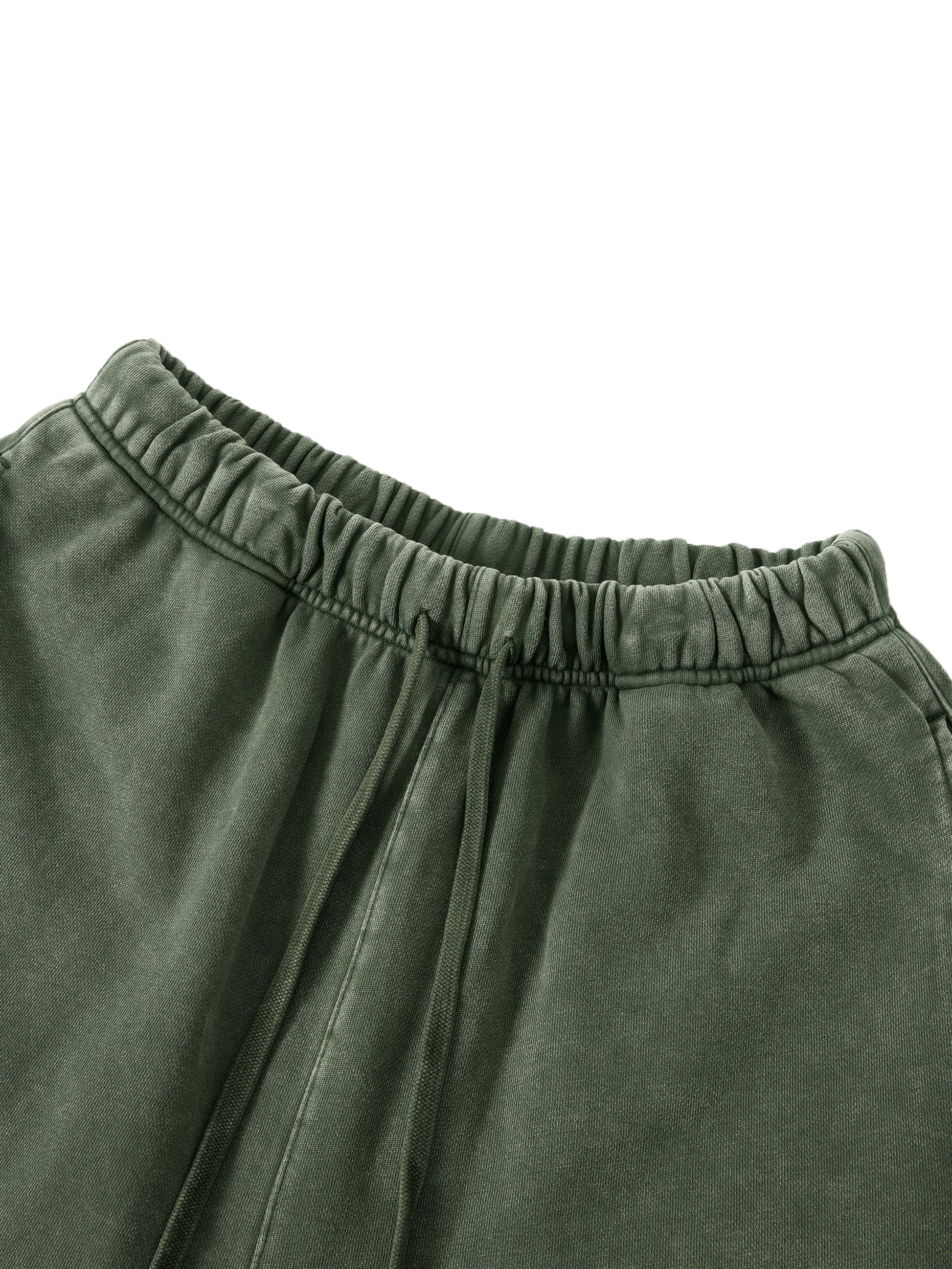 Close-up of green pants with an elastic waistband on a white background