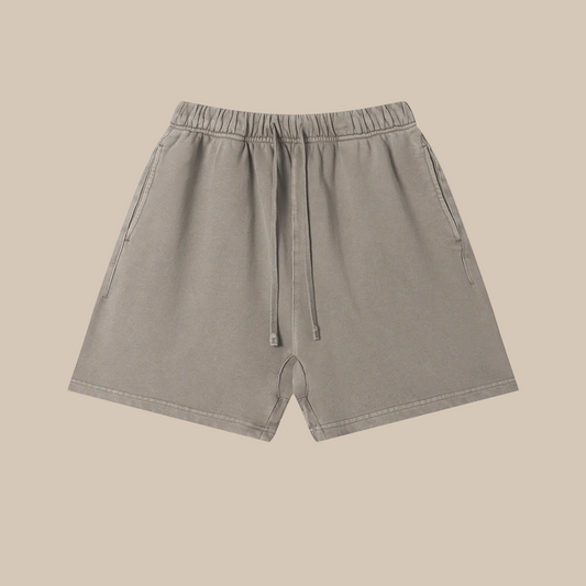 Beige shorts with a brand logo on a white background
