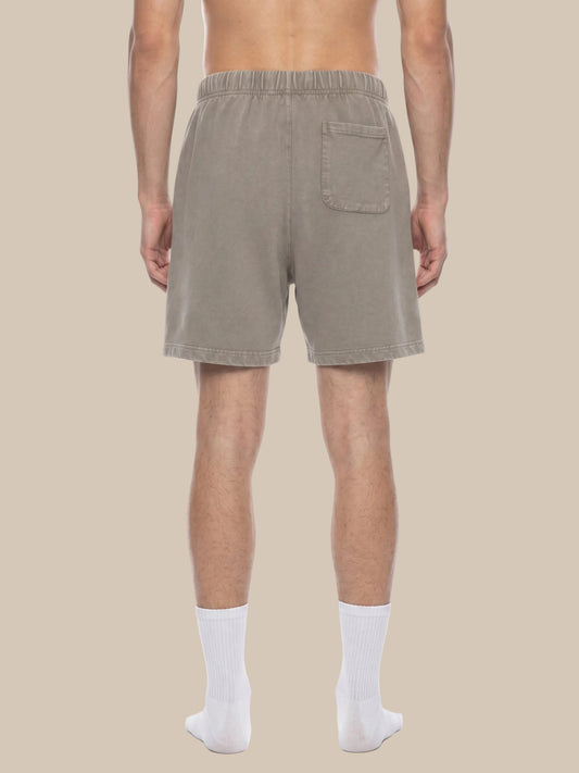 Man wearing beige shorts on a white background