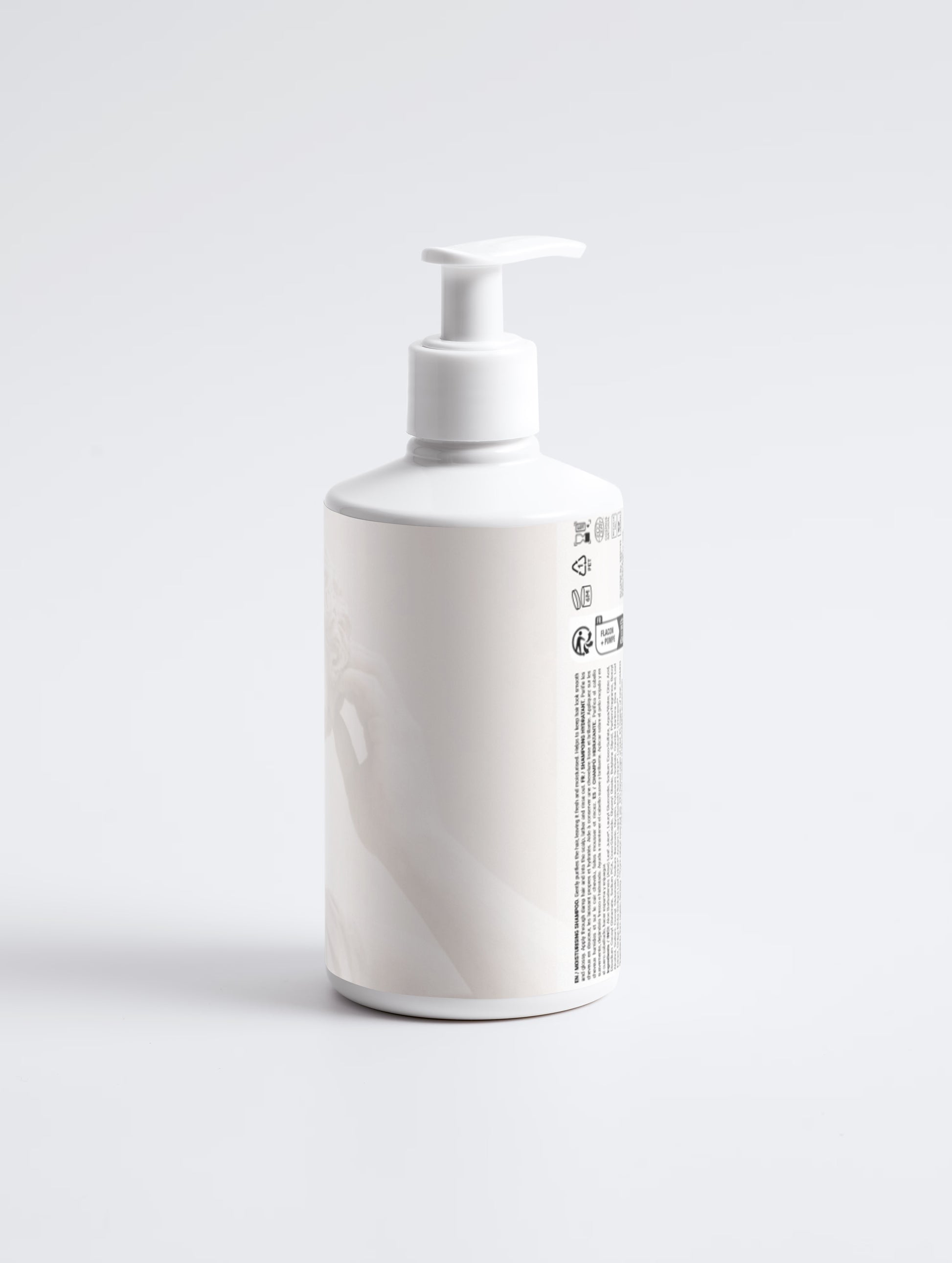 White bottle with pump dispenser on a light gray background