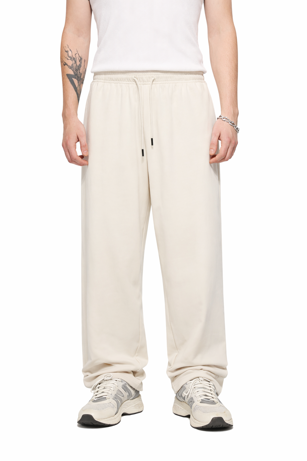 Person wearing cream-colored sweatpants on a white background