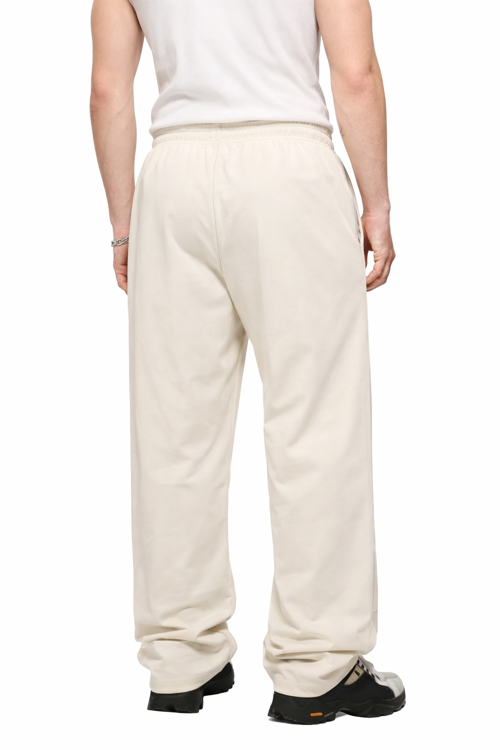 Person wearing white pants on a white background