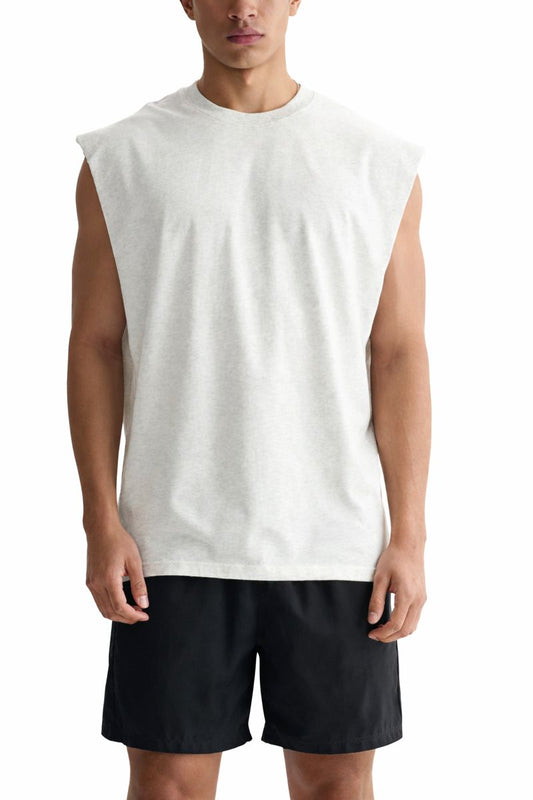 Person wearing a white sleeveless shirt and black shorts on a white background