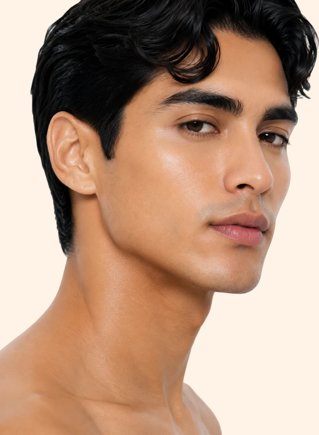 Close-up of a man with short black hair on a plain background