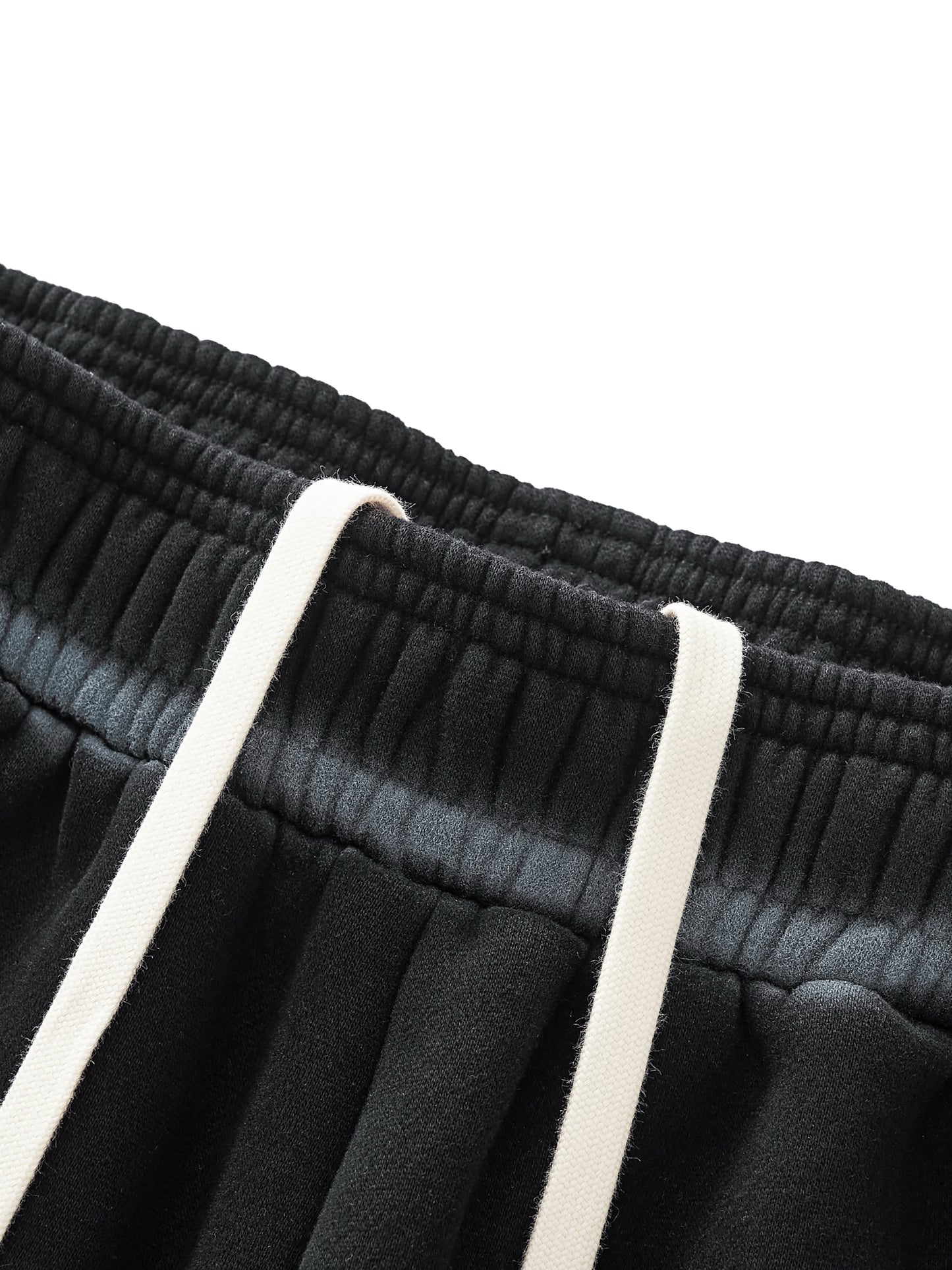 A flat lay of the Future-Homme Ombre Effect Fleece Sweatpants in black front drawstring up close view on a white background.