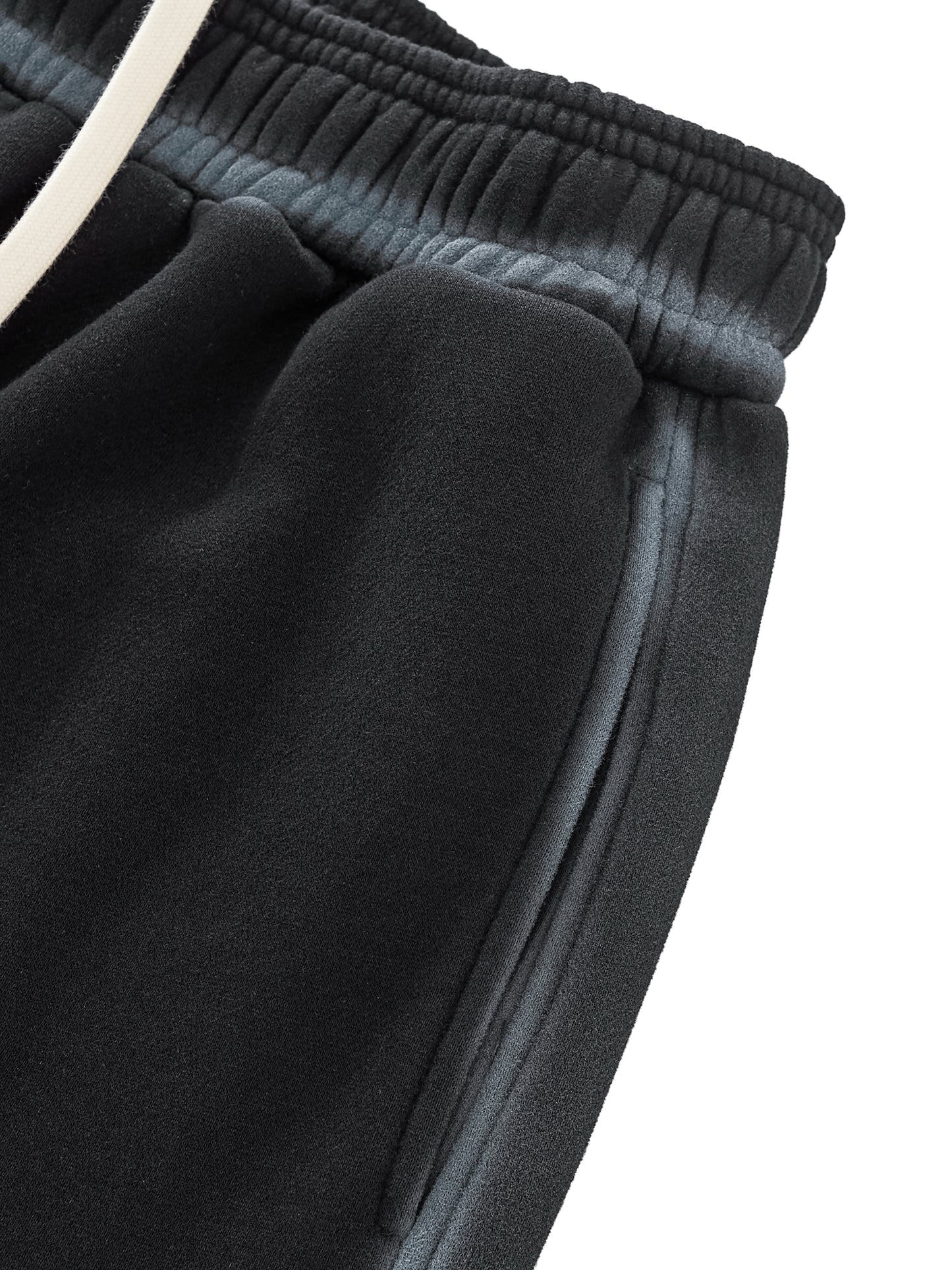 A flat lay of the Future-Homme Ombre Effect Fleece Sweatpants in black front side pocket up close view on a white background.