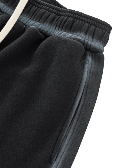 A flat lay of the Future-Homme Ombre Effect Fleece Sweatpants in black front side pocket up close view on a white background.
