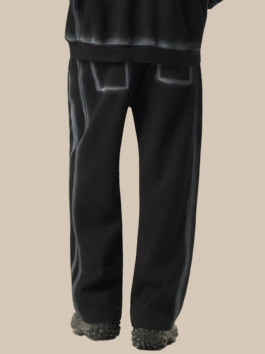 Black pants with textured cuffs on a white background