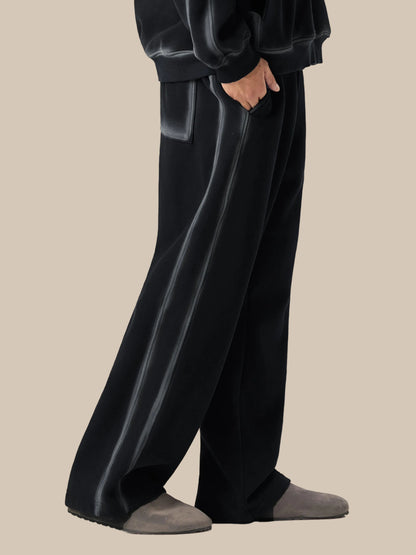 Person wearing black pants and gray socks on a white background