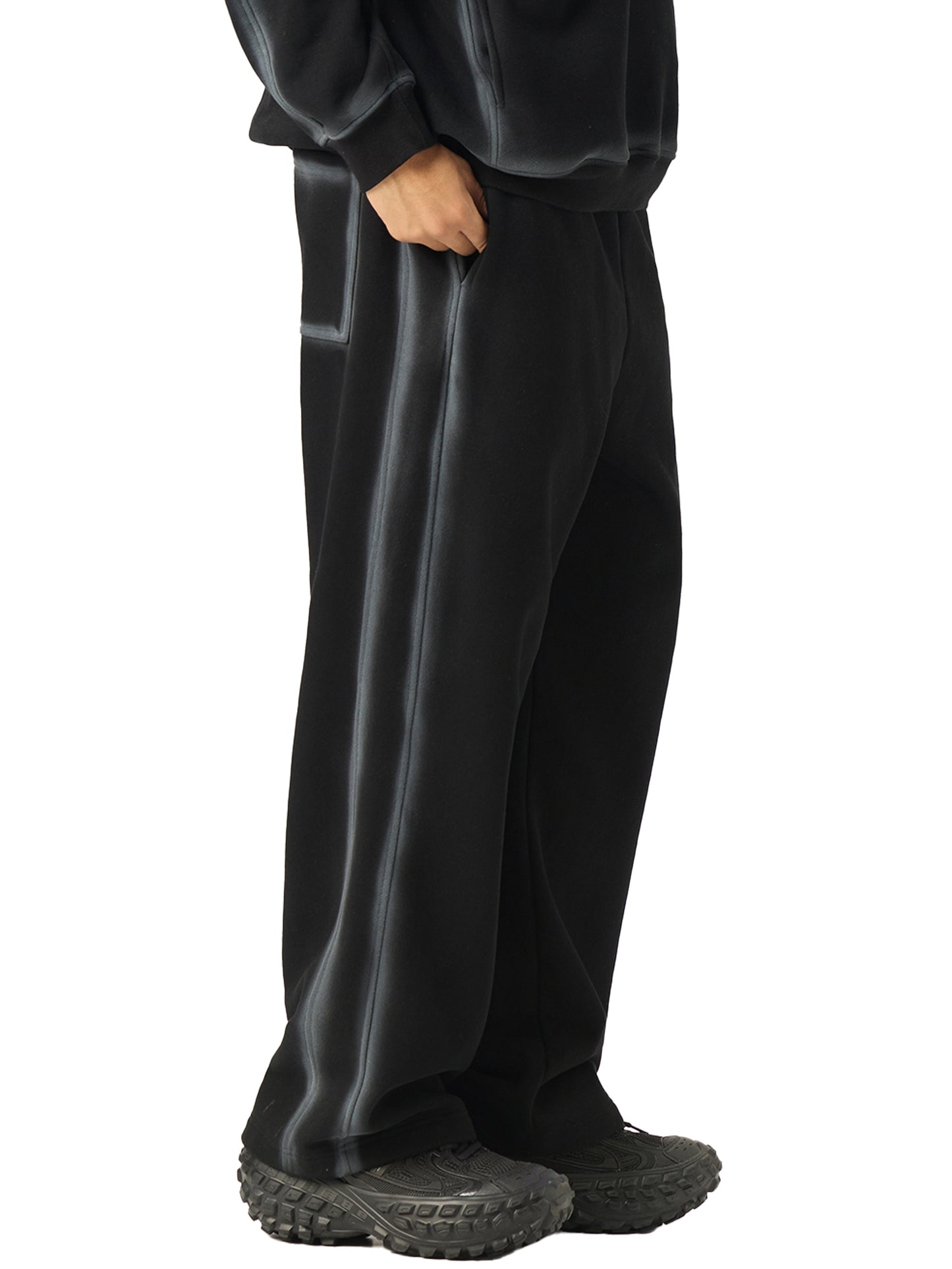 A model wearing the Future-Homme Ombre Effect Fleece Sweatpants in black front side view on a white background.