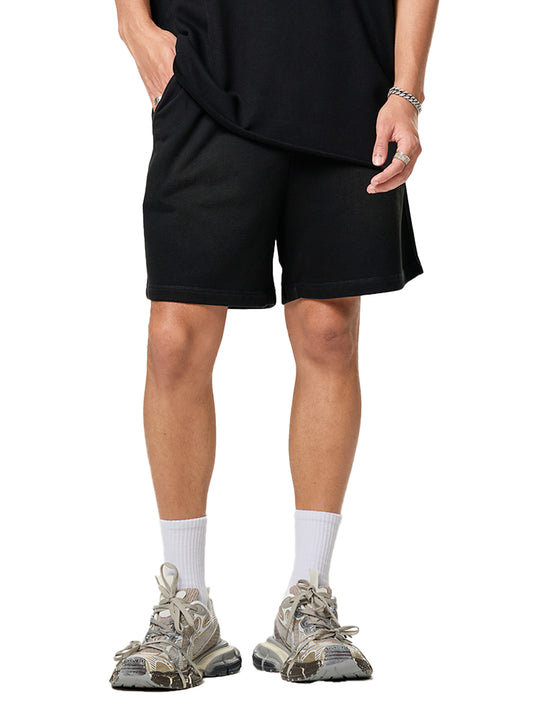Lower half of model wearing the sustainable 250 GSM Future Homme ombré effect raw edge cotton short in black frontside on a white background