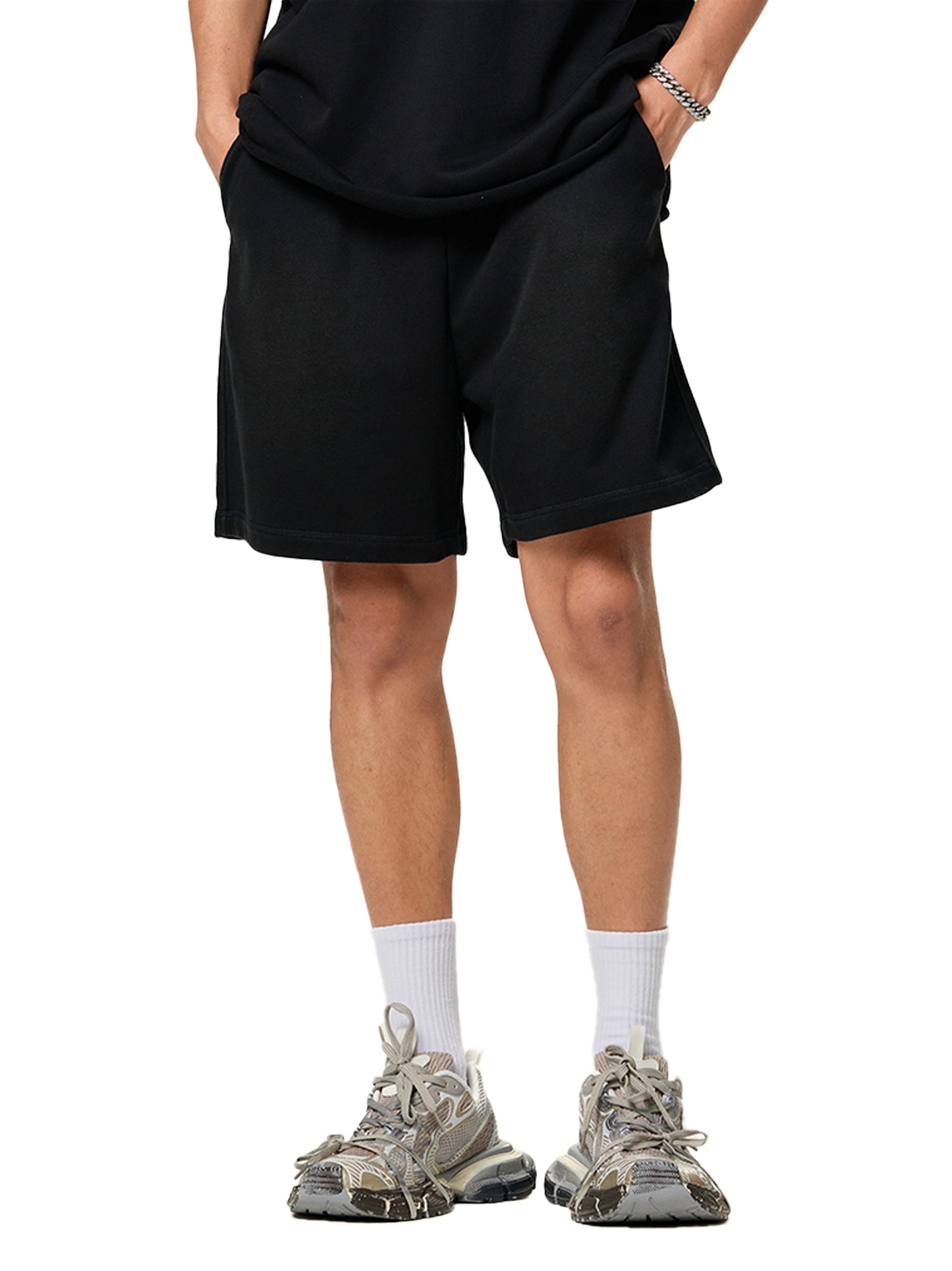 Lower half of model wearing the sustainable 250 GSM Future Homme ombré effect raw edge cotton short in black frontside angle on a white background