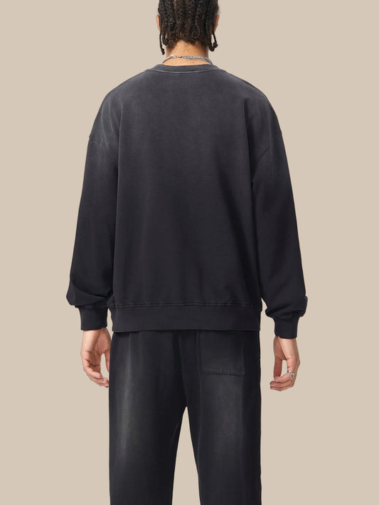 Person wearing a black sweatshirt and pants on a white background