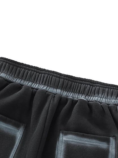 A flat lay of the Future-Homme Ombre Effect Fleece Sweatpants in black back side pocket up close view on a white background.