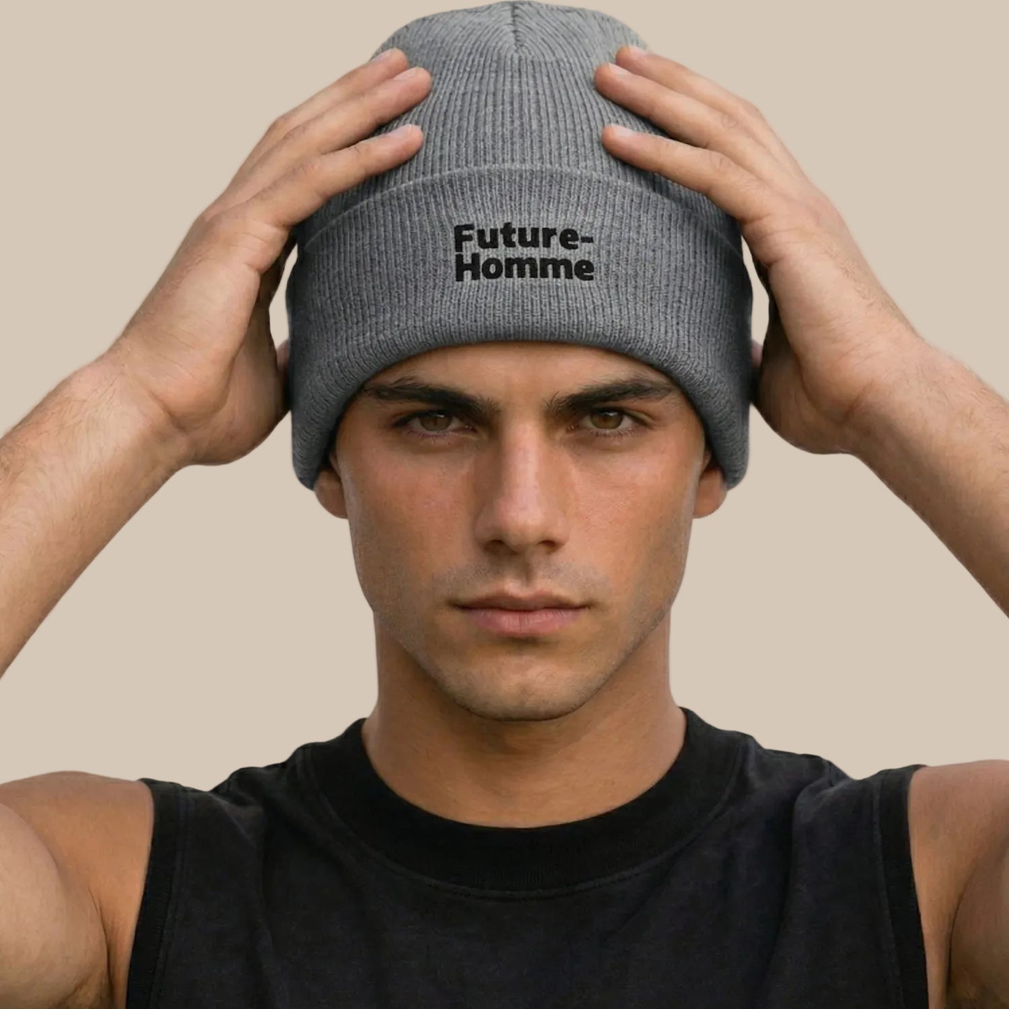 Man wearing a gray beanie with 'Future Homme' text against a plain background