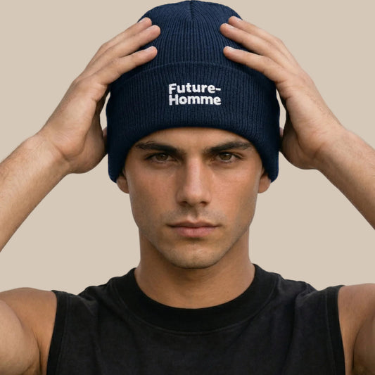 Person wearing a navy blue beanie with 'Future-Homme' text against a plain background
