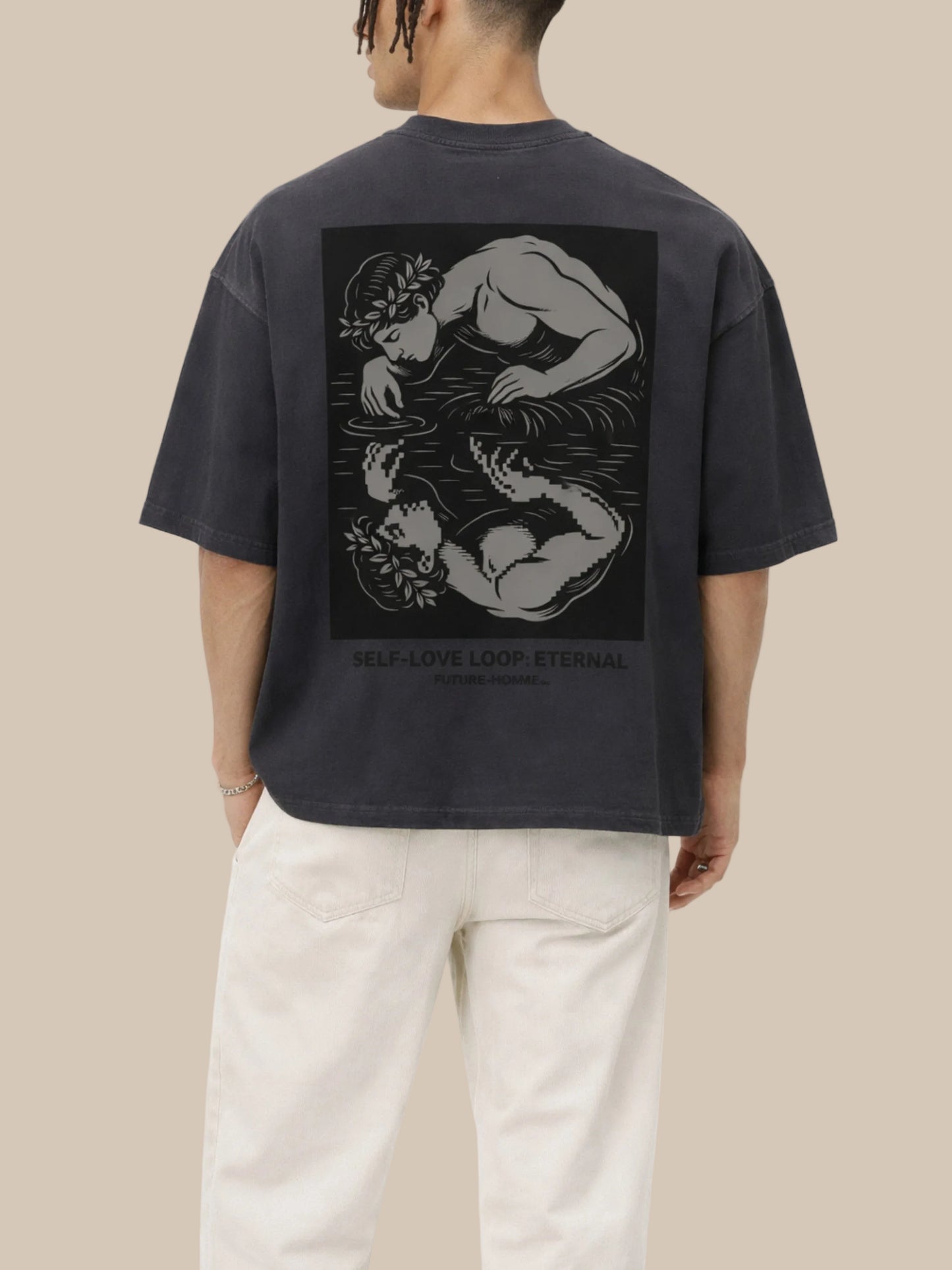 Person wearing a black t-shirt with a graphic design on the back, standing against a white background
