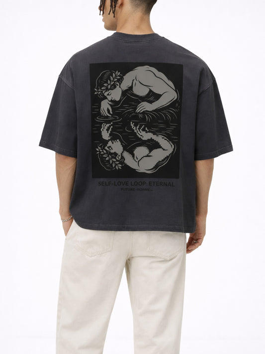 Person wearing a black t-shirt with a graphic design on the back, standing against a white background